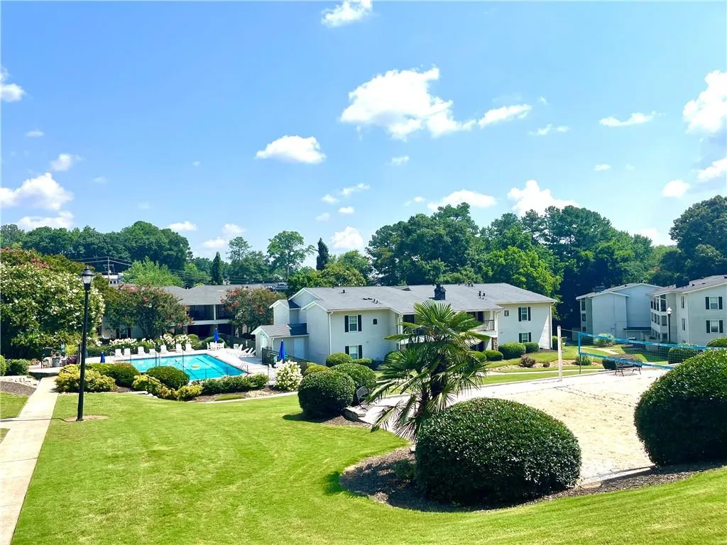 View of property's community featuring a yard, a pool, and a residential view