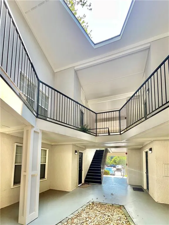 Entrance foyer featuring a high ceiling, a textured wall, and concrete floors