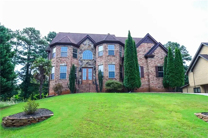Stone and brick exterior with a prominent arched window