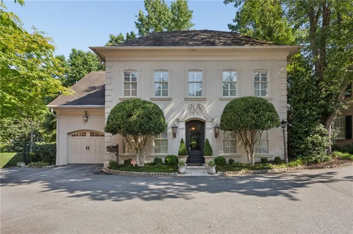 Stucco exterior with stone-look detailing and symmetrical window placement