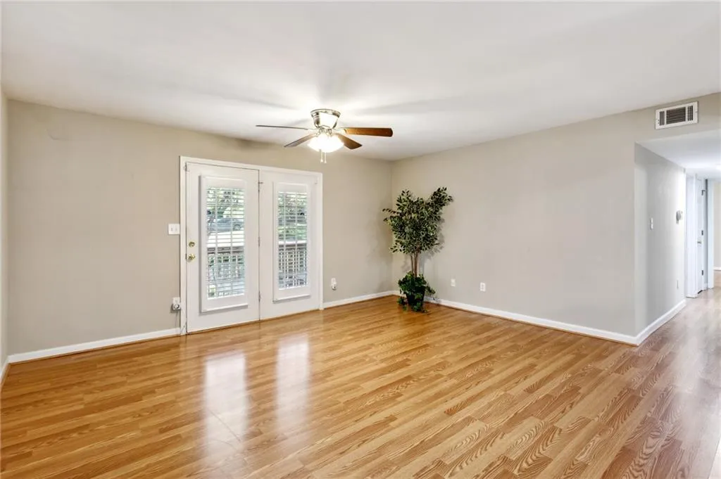 Open Living Room with wood-like flooring through the home! Frendh doors to Covered Porch Patio.  Don't miss the Bonus room opposite the front door!