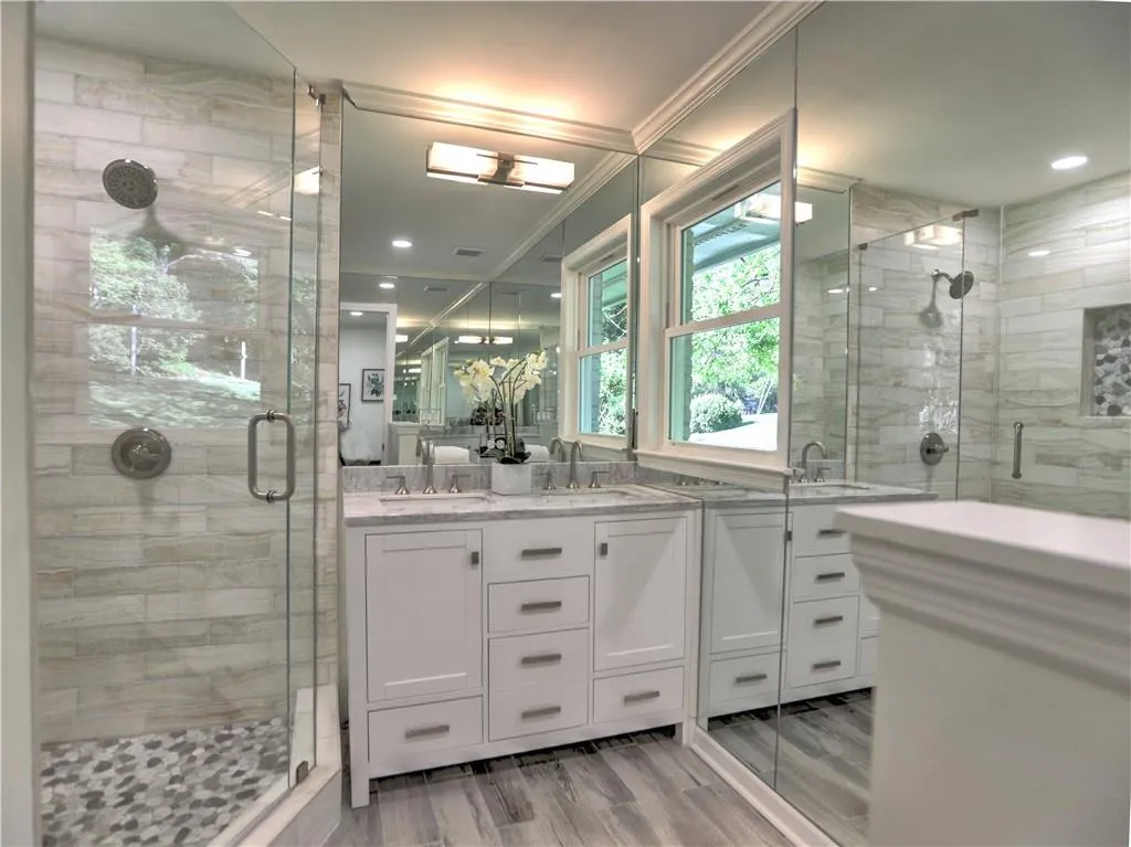 Bathroom featuring walk in shower, hardwood / wood-style floors, dual vanity, and ornamental molding