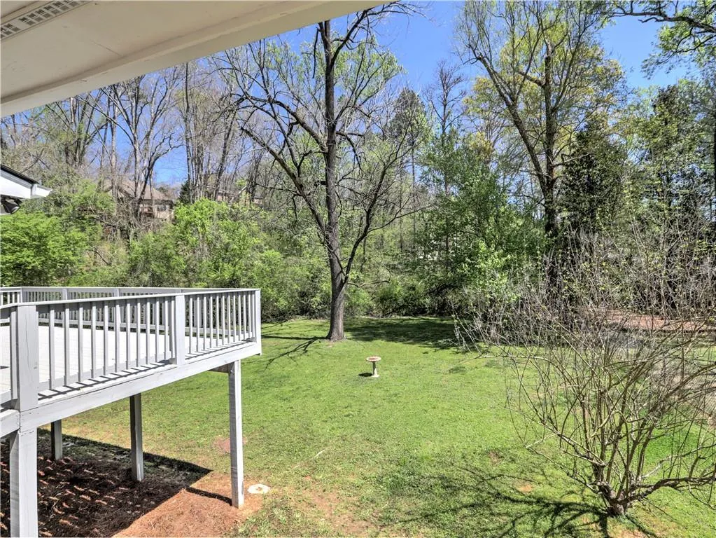 View of yard with a wooden deck
