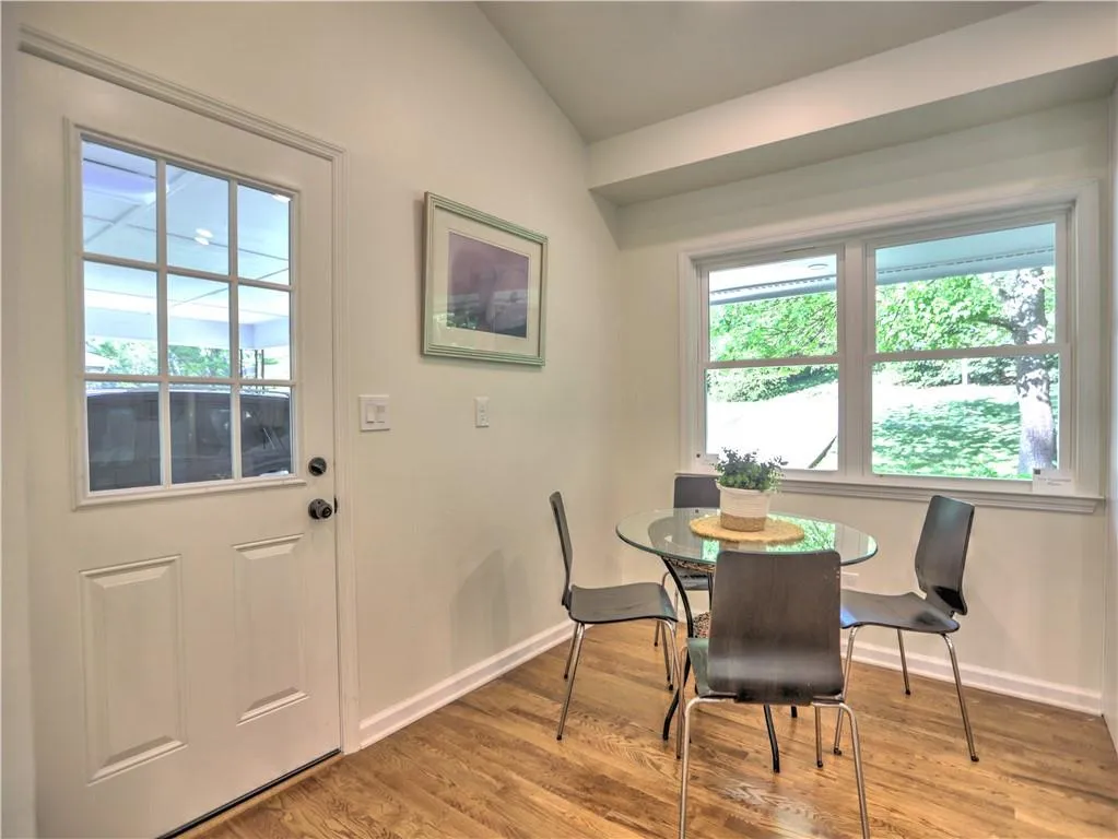Dining room with lofted ceiling and light wood-type flooring
