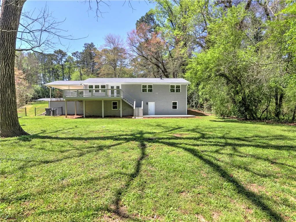 Back of property featuring a yard