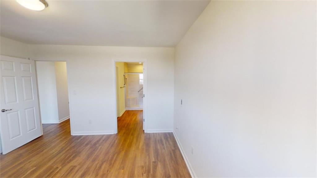 Unfurnished bedroom with dark wood-type flooring
