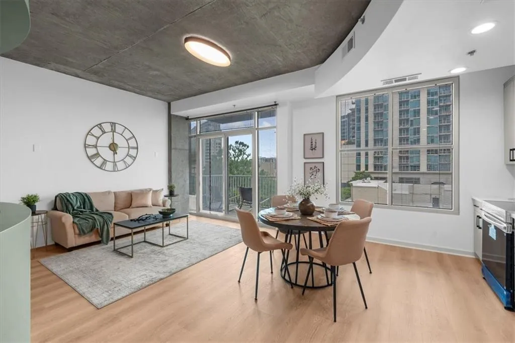 Living Room and Dining room area with fresh designer paint, new wide plank white oak LifeProof LVP flooring, sliding doors to balcony & upgraded lighting