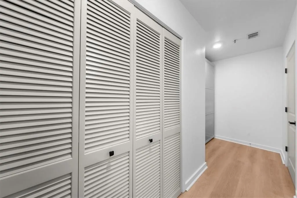 Hallway featuring light wood-style floors and recessed lighting