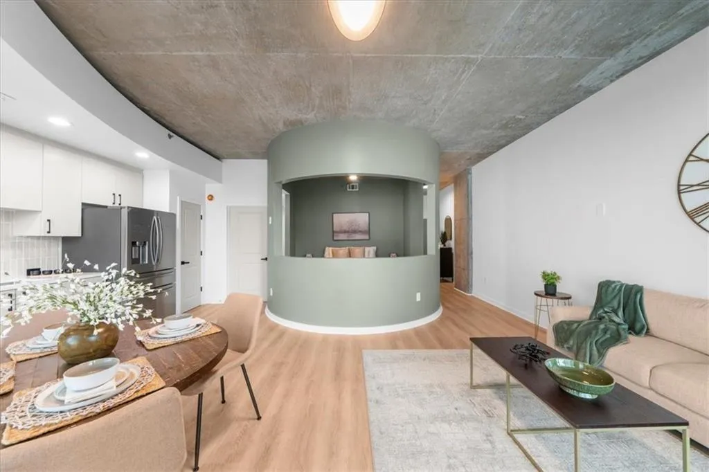 Living room featuring light wood-style floors and baseboards