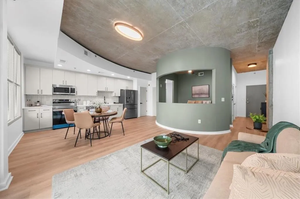 Living area featuring light wood-style flooring and baseboards