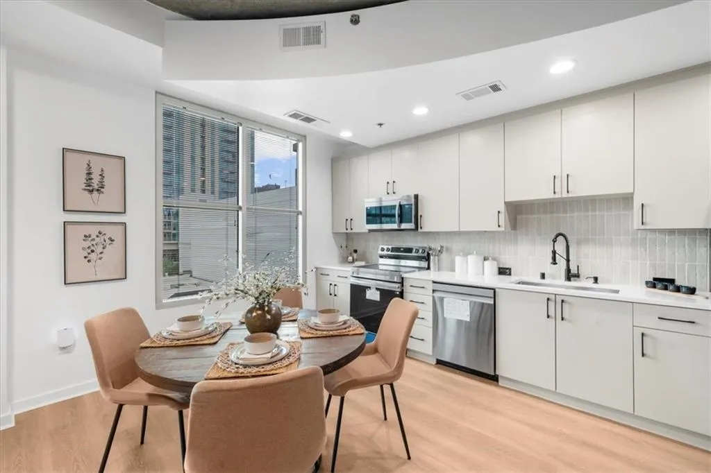 Kitchen featuring Calcutta Milan quartz countertops, Edward Martin ceramic backsplash, light oak Lifeproof flooring, Brand new Smart appliances and modern refinished cabinetry