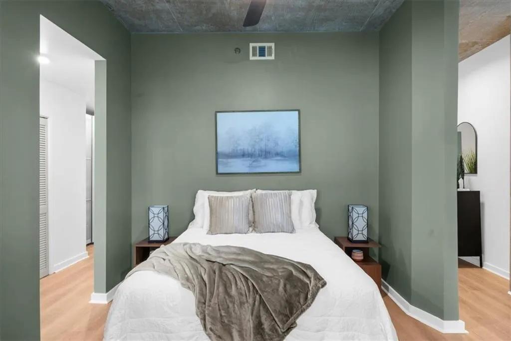 Newly painted Bedroom featuring light wood-style floors and ceiling fan