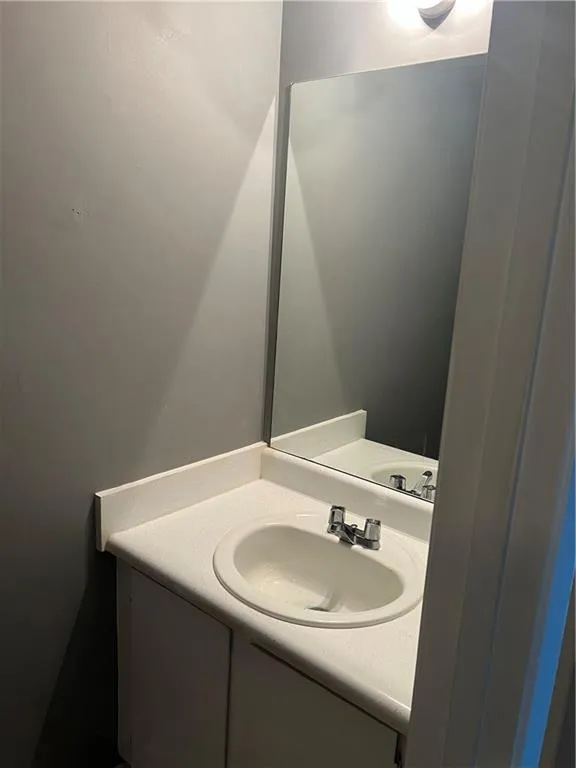Bathroom featuring vanity with extensive cabinet space