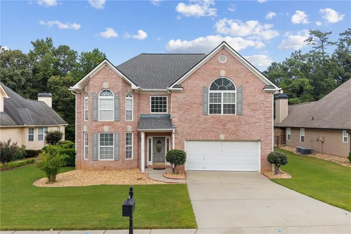 Brick exterior with a gabled roof and arched window accents