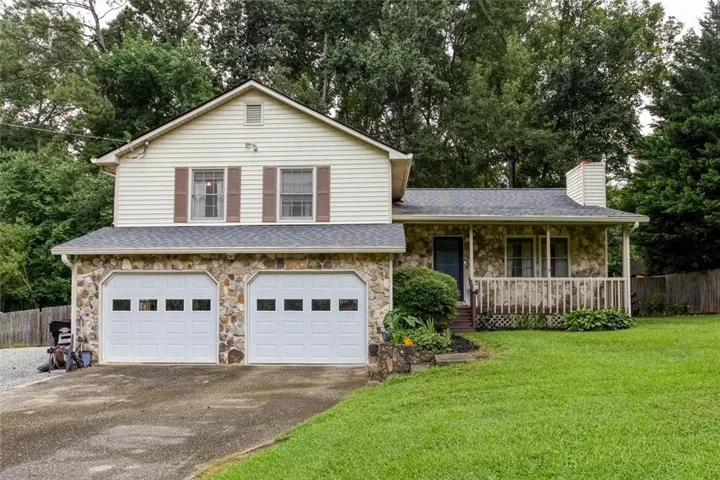 Two-story exterior with stone facade, siding, and a gabled roof