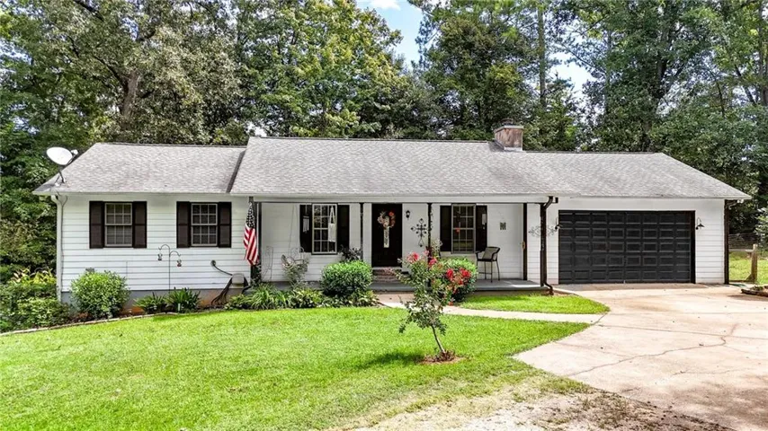 White siding exterior with black window shutters