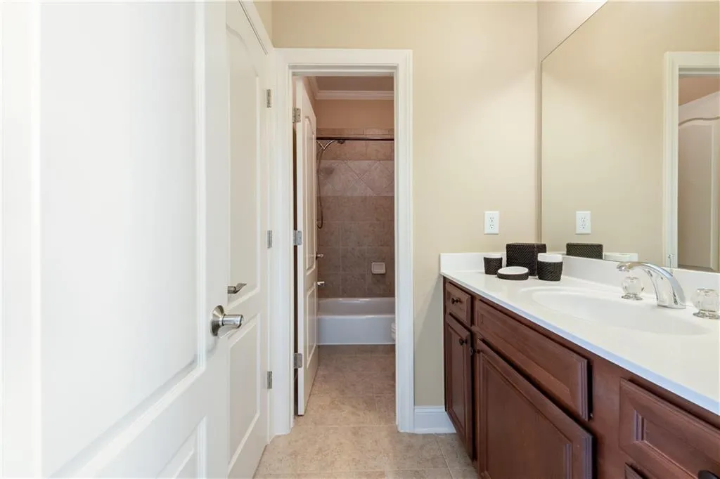 Full bathroom with tile patterned flooring and vanity