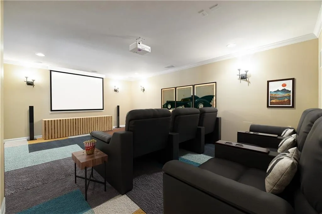 Carpeted cinema with baseboards, recessed lighting, and crown molding