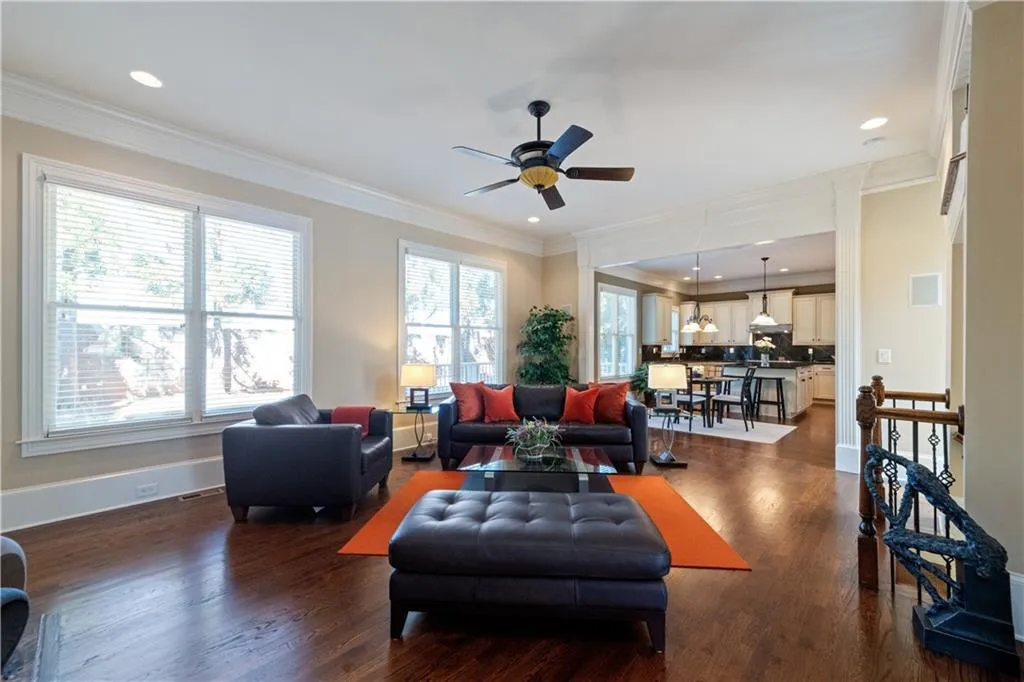 Living room with ornamental molding and dark wood finished floors