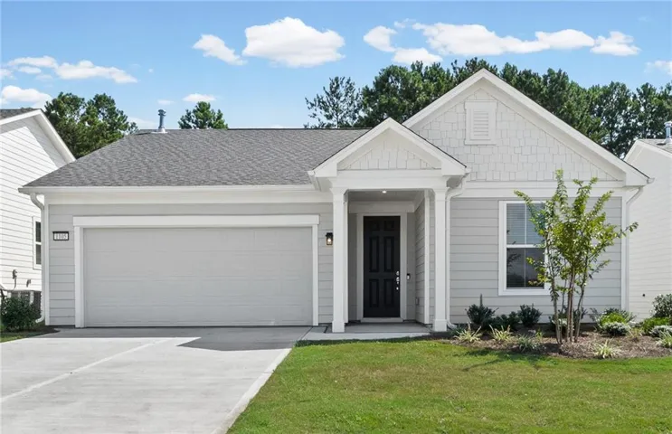 Modern single-story home featuring a clean white exterior with board-and-batten siding, a welcoming covered entry portico with dark double doors, and a two-car garage with paneled doors