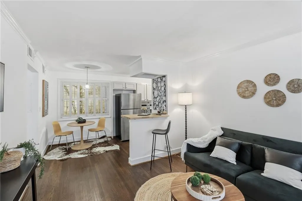 Open-concept living space with dinette area stainless appliances and gas stove in the kitchen