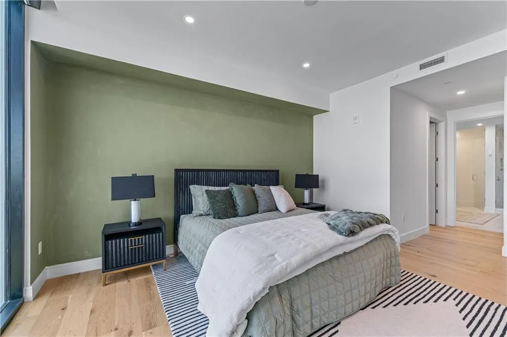 Bedroom with light wood-style floors and recessed lighting