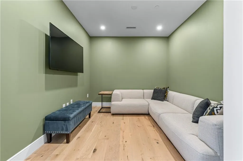 Living area featuring hardwood / wood-style flooring and recessed lighting