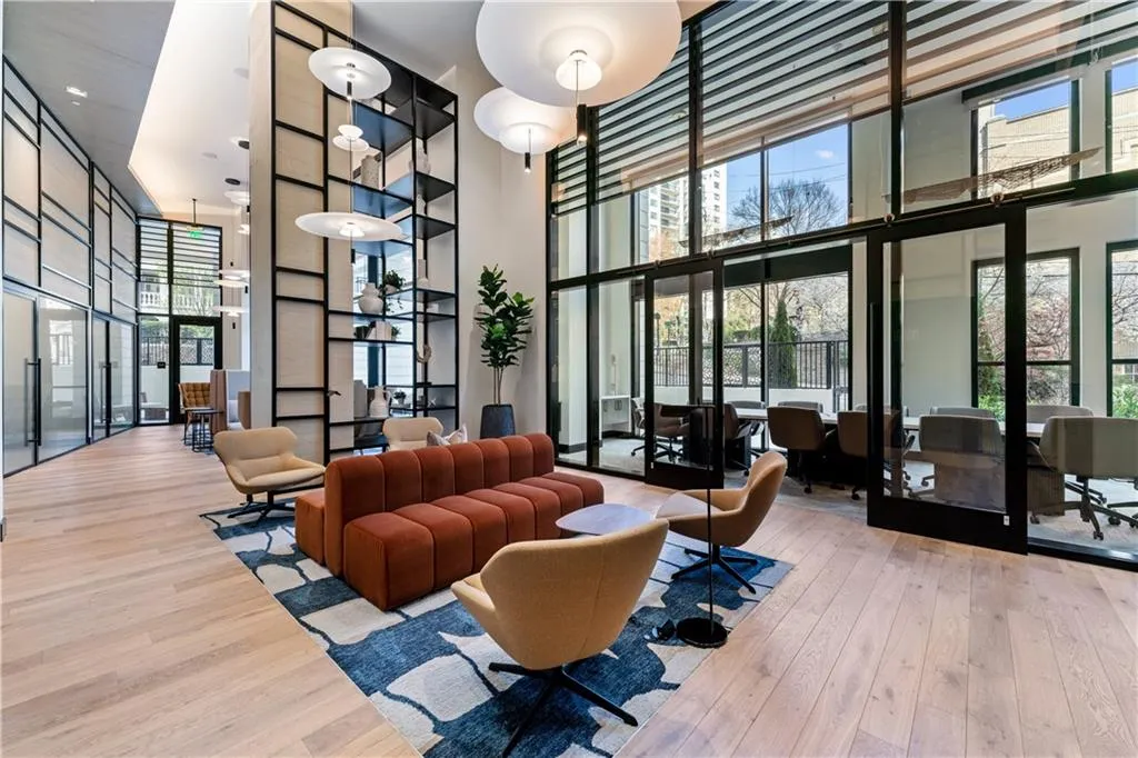 Common area with a towering ceiling and floor to ceiling windows
