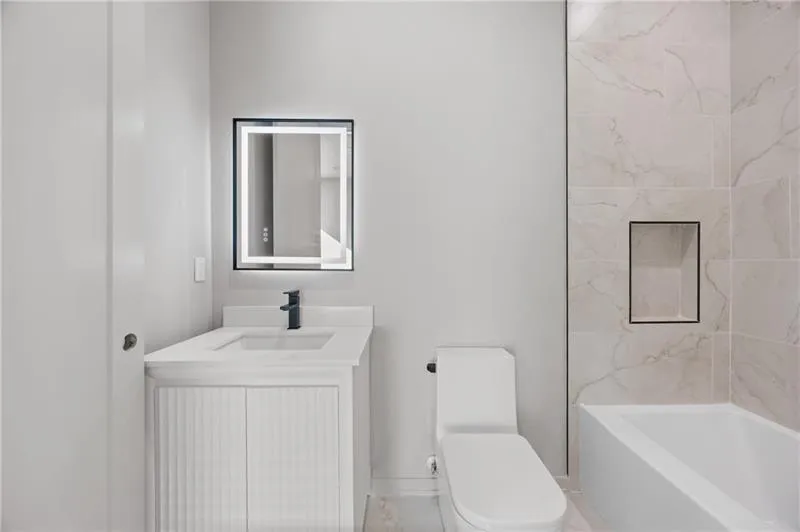 Bathroom featuring vanity and shower / bathtub combination