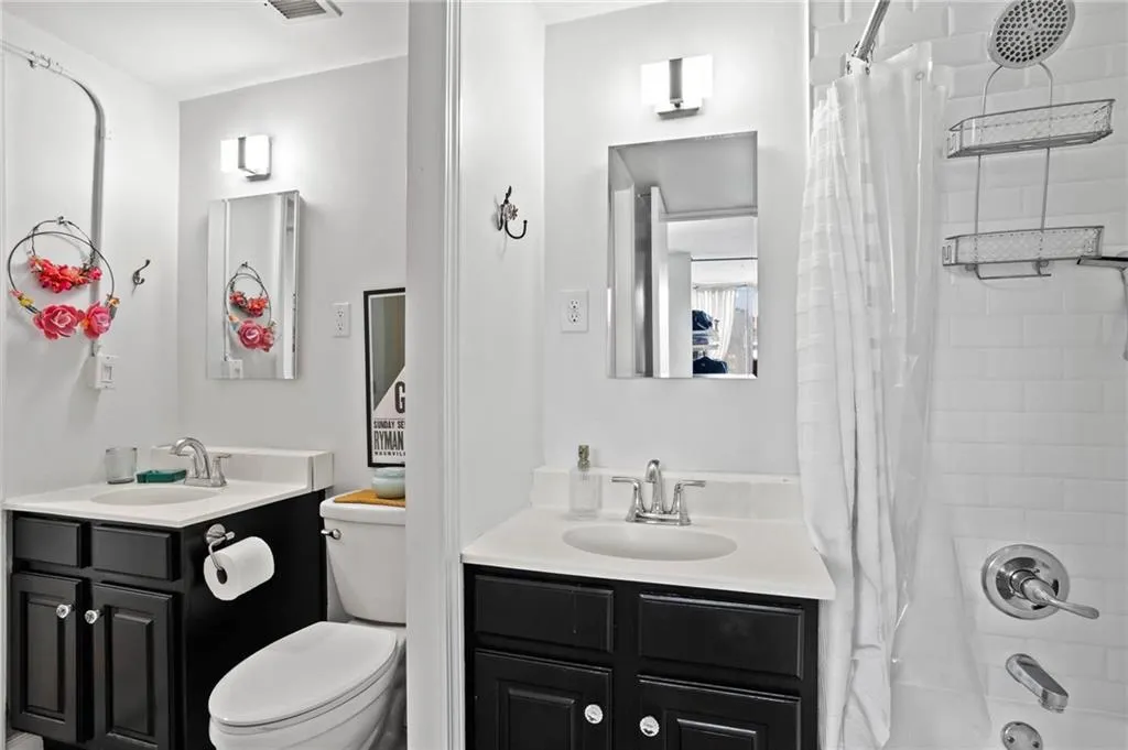 Full bathroom with shower / bathtub combination with curtain and vanity