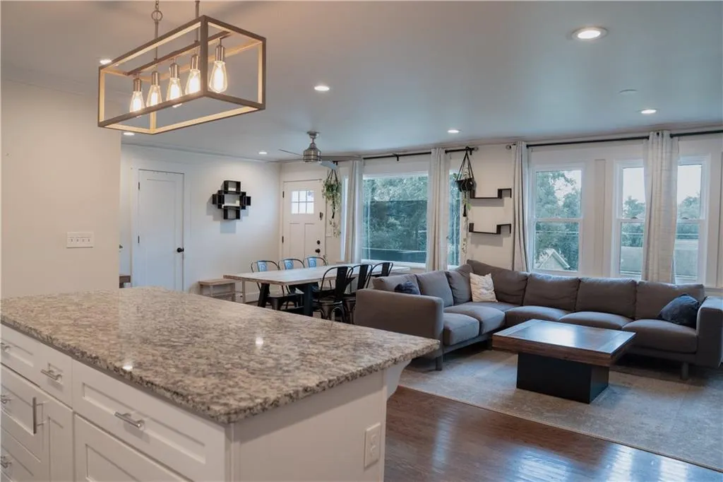 Kitchen with dark wood-style floors, a ceiling fan, recessed lighting, white cabinetry, and crown molding