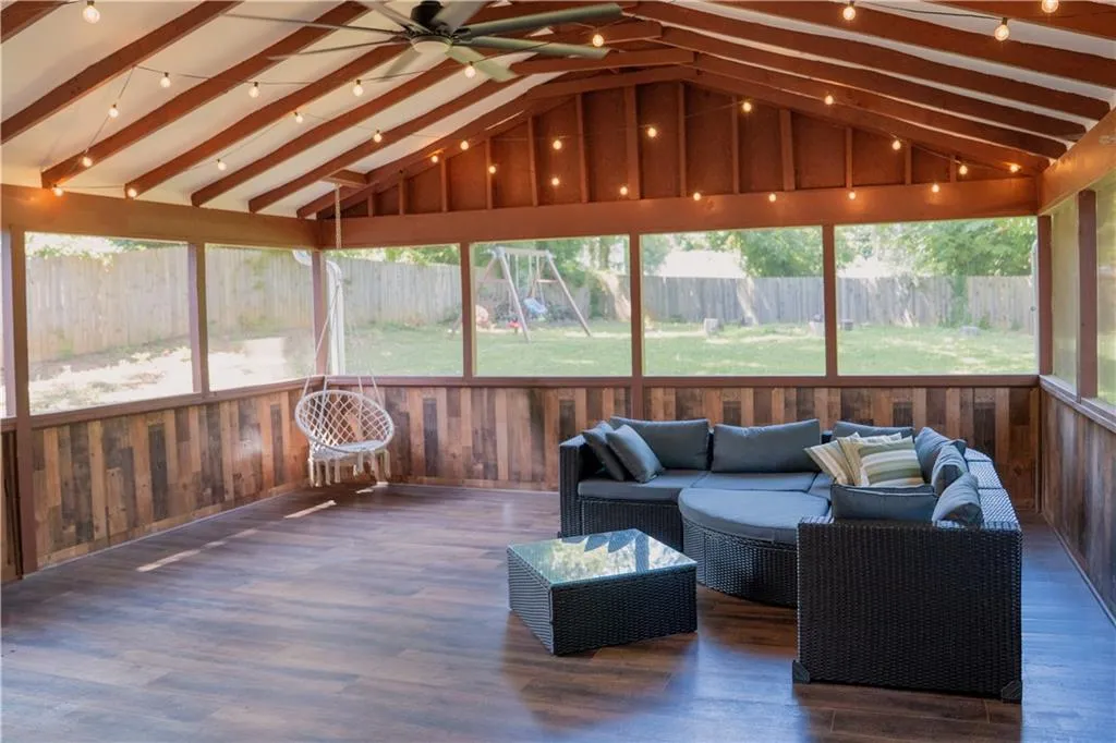 Sunroom / solarium featuring ceiling fan and an outdoor hangout area
