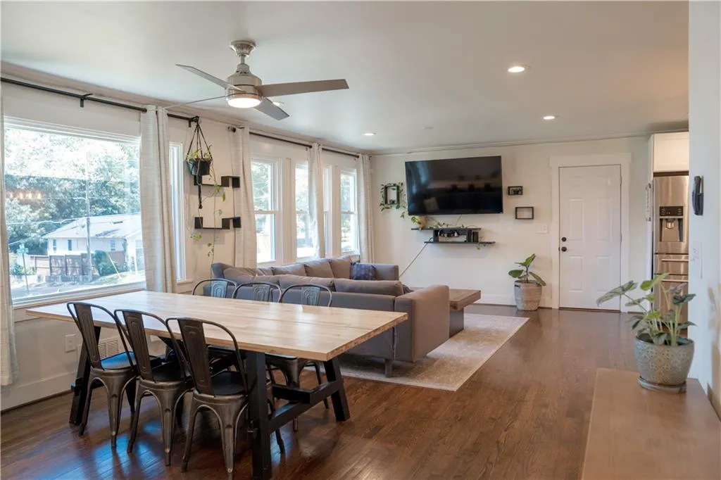 Dining area featuring ornamental molding, a ceiling fan, dark wood-type flooring, plenty of natural light, and recessed lighting