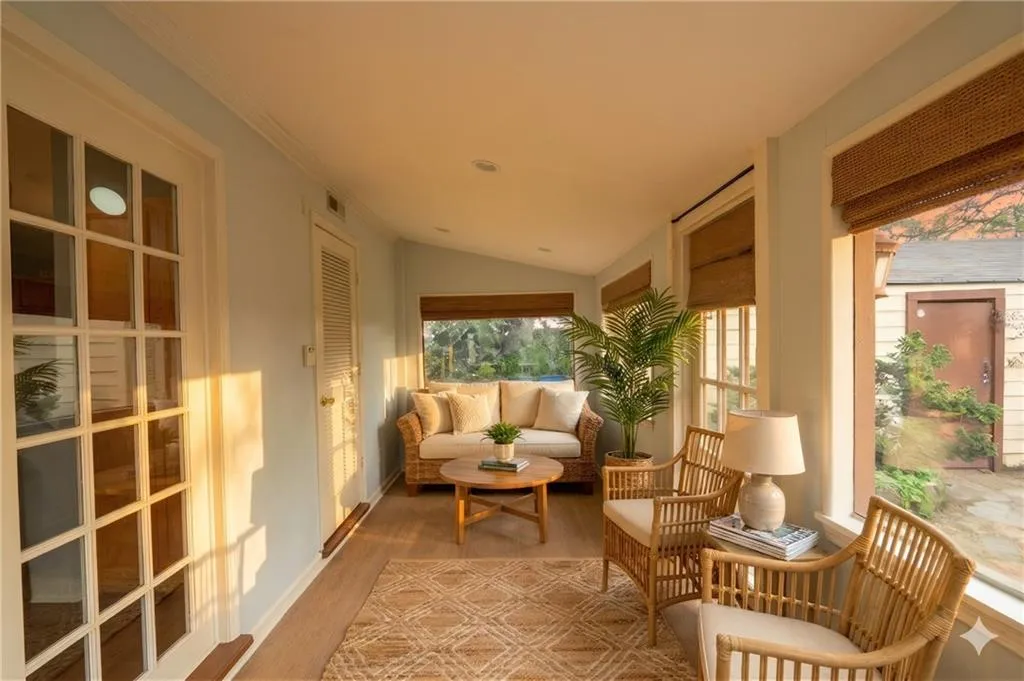 Sunroom featuring lofted ceiling, wood finished floors, and recessed lighting