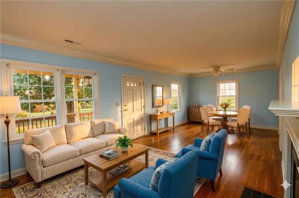 Living area with dark wood finished floors and crown molding