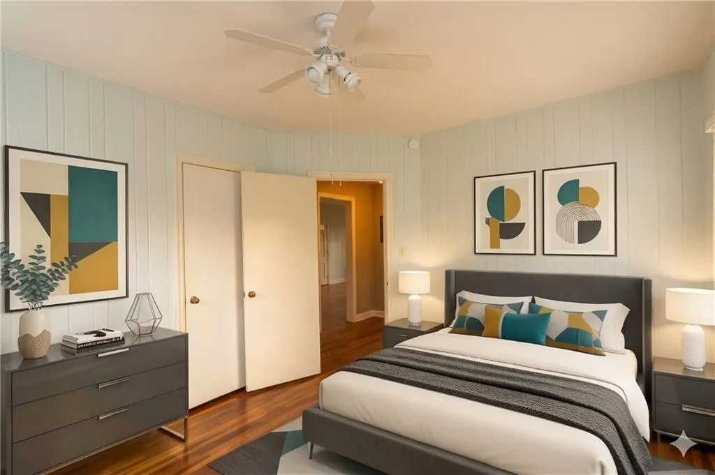 Bedroom with dark wood-style floors and a ceiling fan