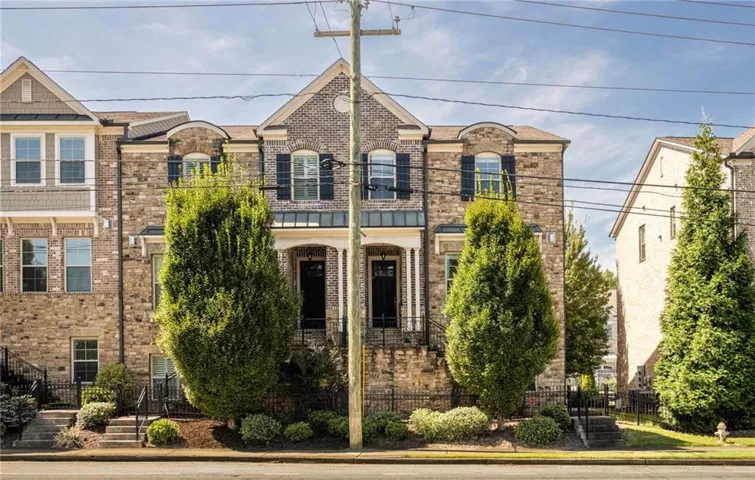 Brick facade with dark shutters and a gabled roofline