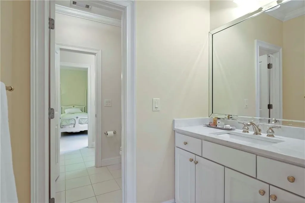This Jack & Jill bathroom has been updated with marble countertops