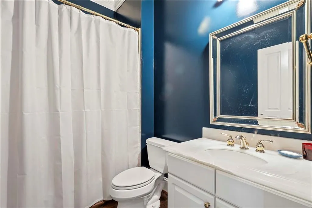 This full bath is on the main level, off the front den and hallway