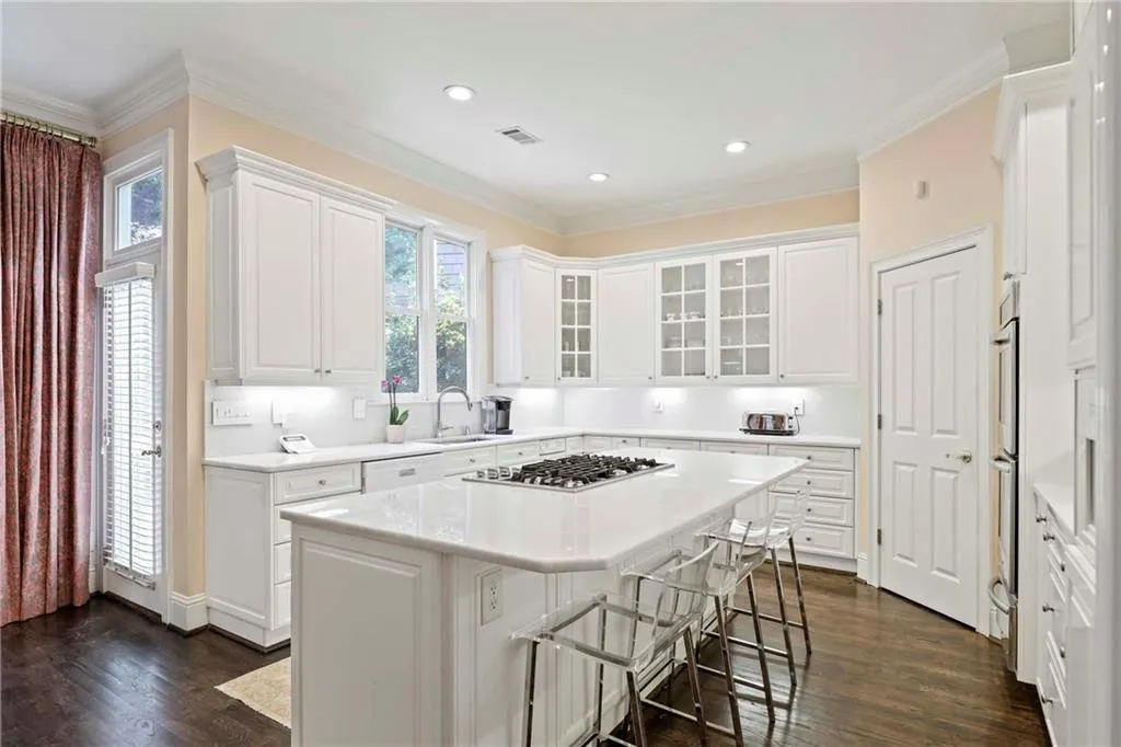 Light and bright kitchen features beautiful marble countertops