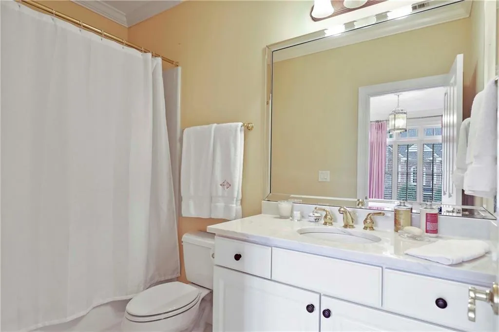 This ensuite bath has also been updated with marble countertops.