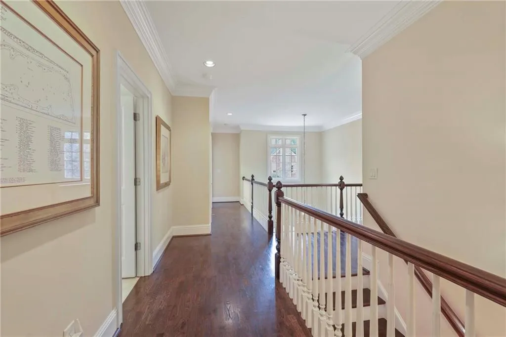 Here is a look at the landing at the top of the stairs - beautiful hardwood floors are in the primary bedroom and upstairs hallway
