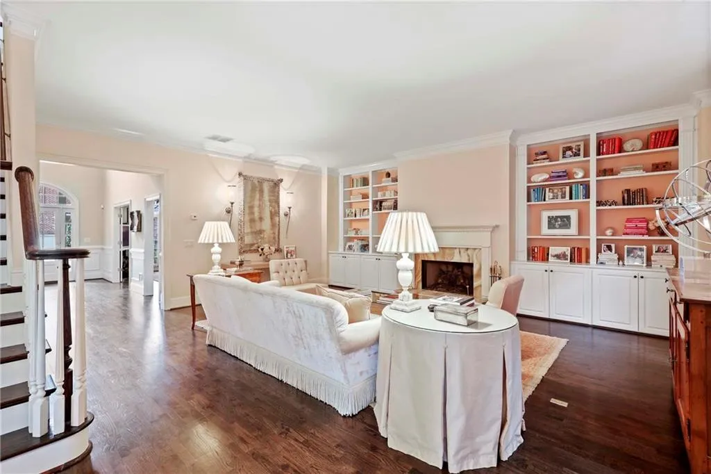 This large living room has a fireplace flanked by built-in bookcases