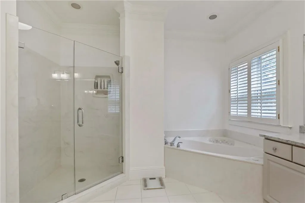 Walk-in shower with glass enclosures and a separate soaking tub!