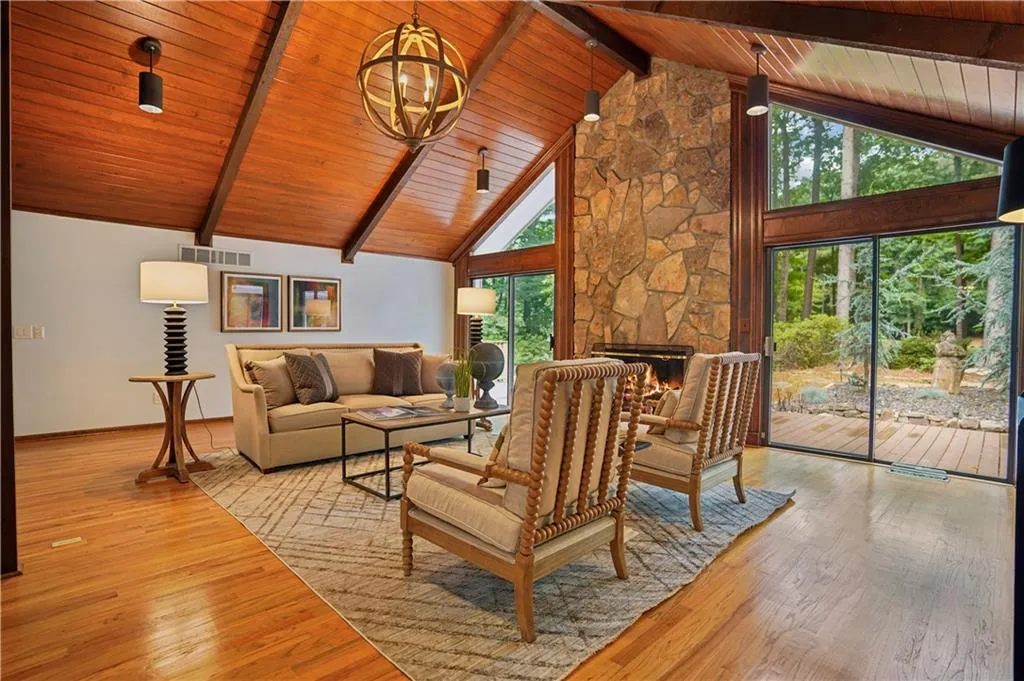 Living room featuring plenty of natural light, high vaulted ceiling, wood ceiling, and wood-type flooring