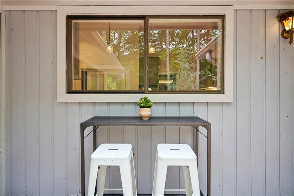 sliding glass window over the sink creating a diner window to the outside