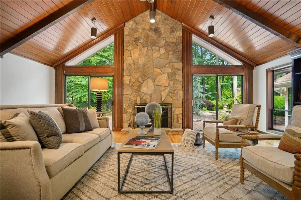 Living room with high vaulted ceiling, beam ceiling, hardwood / wood-style floors, and wood ceiling