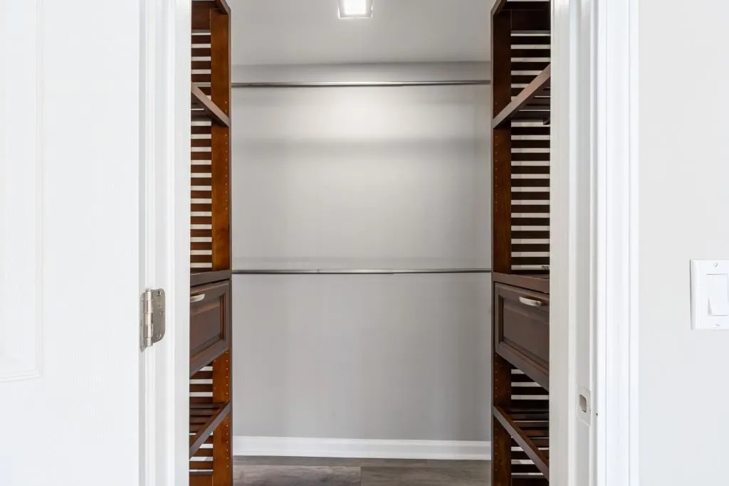 Secondary bedroom walk in closet with new additional shelving space Secondary bedroom walk in closet with new additional shelving space