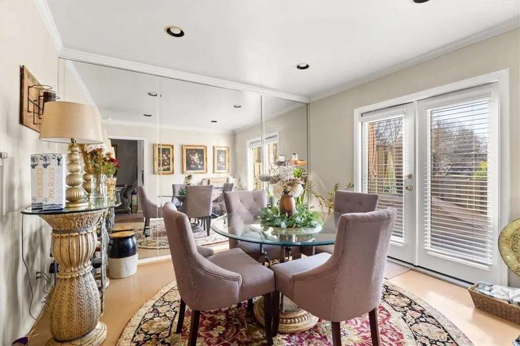 Dining area with ornamental molding, french doors, and recessed lighting