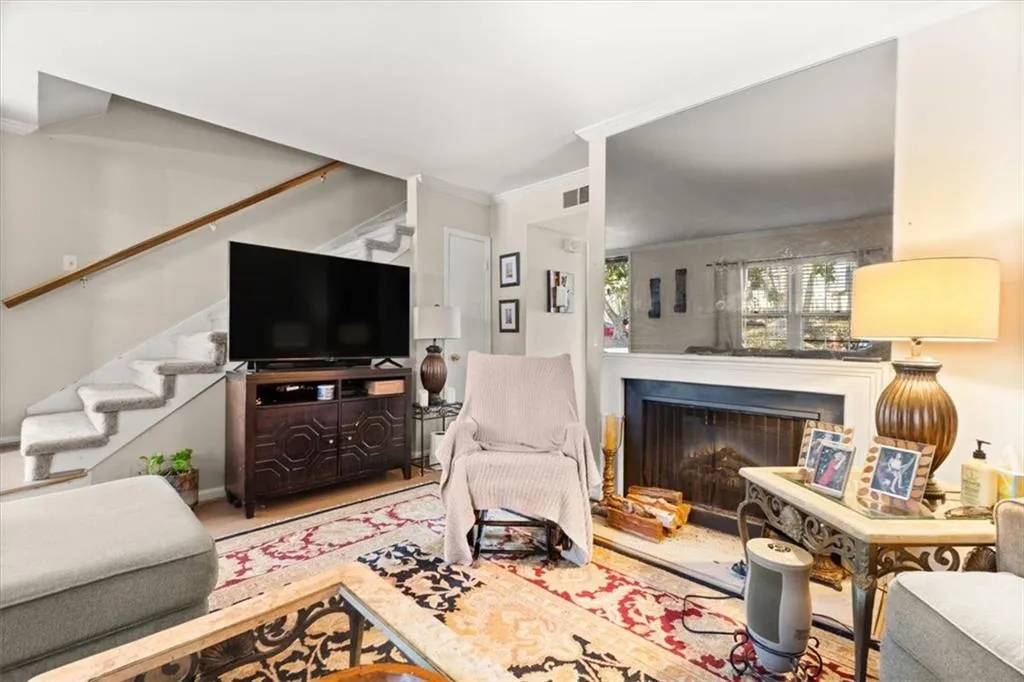 Living area featuring crown molding and a fireplace